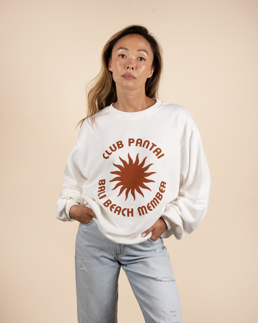 A white sweatshirt with 'Club Pantai Bali Beach Member'