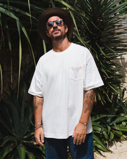 Man wearing a white t-shirt from Club Pantai merch