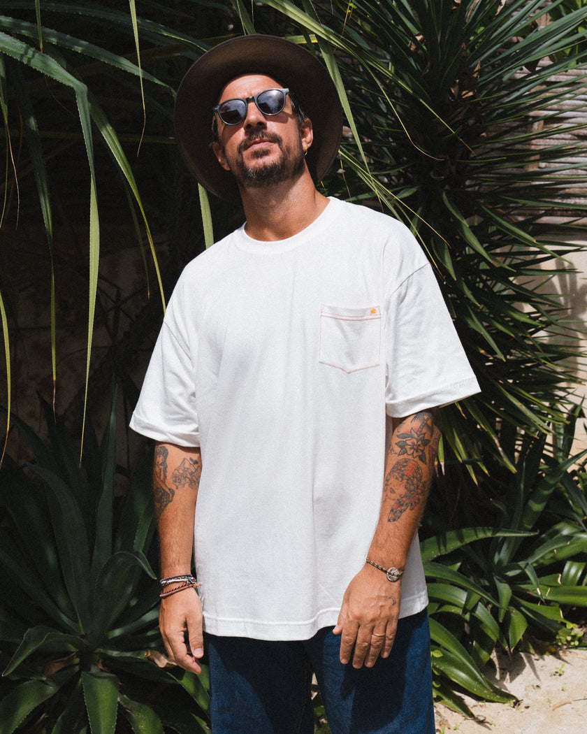 Man wearing a white t-shirt from Club Pantai merch